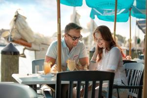 a man and a woman sitting at a table at Annapolis Waterfront Hotel, Autograph Collection in Annapolis