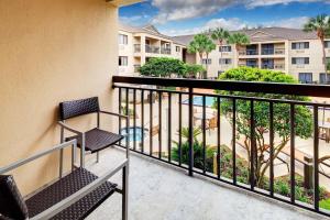 a balcony with chairs and a view of a resort at Courtyard by Marriott Ocala in Ocala