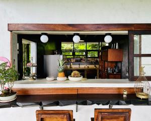 a kitchen with a counter with two chairs at The Hill Panama in Cambutal +57 photos