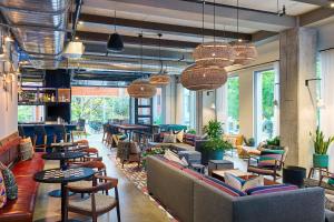 a lobby with couches and chairs and tables and windows at Aloft Austin Downtown in Austin