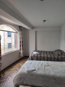 Ένα ή περισσότερα κρεβάτια σε δωμάτιο στο Habitación cómoda y confortable en el corazón de Puno