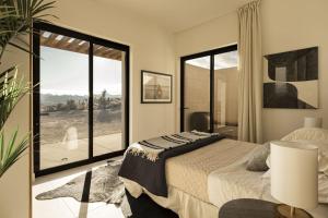 a bedroom with a bed and a large window at Fleur in Joshua Tree +32 photos