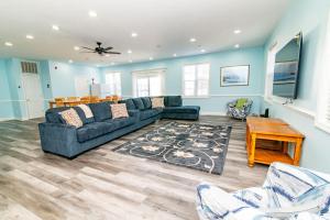 a living room with a couch and a table at Tropical Rays Huge Cherry Grove House w Pool in Myrtle Beach