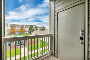 a door to a balcony with a view of a playground at Luxury King Beds Pool Gym - Near Hill AFB in Clearfield