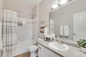 a white bathroom with a sink and a toilet at Luxury King Beds Pool Gym - Near Hill AFB in Clearfield +8 photos