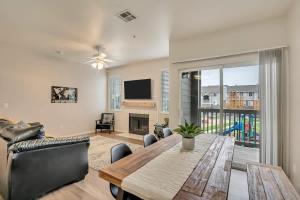 a living room with a dining room table and a television at Luxury King Beds Pool Gym - Near Hill AFB in Clearfield