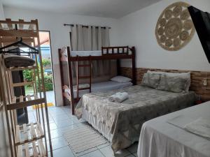 um quarto com dois beliches e uma varanda em Torre do Sol em Praia do Francês