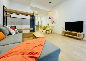 a living room with a bed and a flat screen tv at LOFT 1 - Space & Conform Close To Center in Valencia
