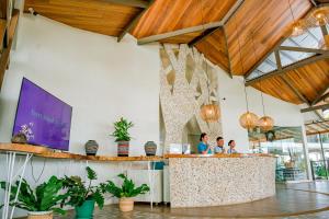 a group of people standing at a counter in a restaurant at Paras Beach Resort - Camiguin in Mambajao