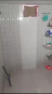 a bathroom with a shower with a glass door at Arail ghat homestay in Prayagraj