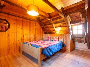 a bedroom with a bed in a wooden cabin at Maison de village 8 personnes à Loudervielle avec Wifi - FR-1-695-71 in Loudenvielle