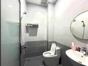 a bathroom with a toilet and a sink and a mirror at Nhà Nghĩ Bà Rịa - Bình An in Ấp Nam +9 photos
