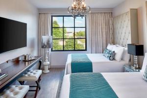 a hotel room with two beds and a window at The Edwin Hotel, Autograph Collection in Chattanooga +83 photos