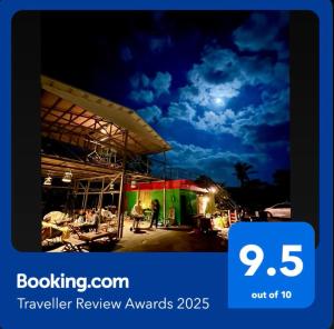 a sign that says travel review awards at night at This is Okinawa Nature Stay Yanbaru Forest in Motobu