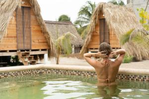 a man standing in the water in a swimming pool at Nattivo Chacahua in Guayabas