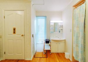 a bathroom with a sink and a white door at Soen 1996 Villa in Sapporo +71 photos