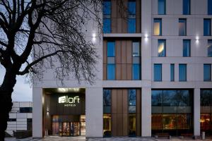 a building with a sign on the front of it at Aloft by Marriott Birmingham Eastside in Birmingham