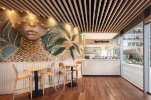 a restaurant with a mural of a woman at W Bogota in Bogotá