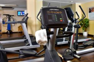 a gym with tread machines and a monitor on a treadmill at Courtyard by Marriott Hamburg Airport in Hamburg