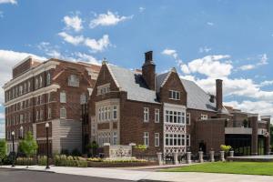 a large brick building on a street at The Lytle Park Hotel, Autograph Collection in Cincinnati