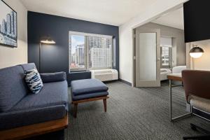 a living room with a couch and a window at Courtyard by Marriott Chicago Downtown/River North in Chicago