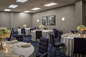 a conference room with tables and chairs and flowers at Courtyard by Marriott Chicago Downtown/River North in Chicago +46 photos