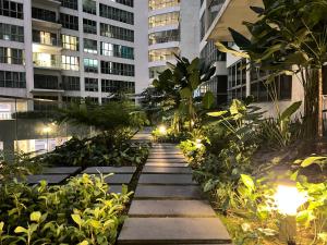 a walkway in the middle of a city at night at Empire Hostel Regalia in Kuala Lumpur
