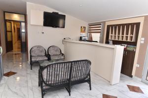 a living room with two chairs and a bar at Prenociste Gazela in Pirot