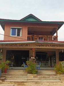 a house with some blue chairs in front of it at Sophea's guesthouse in Kaôh Kon