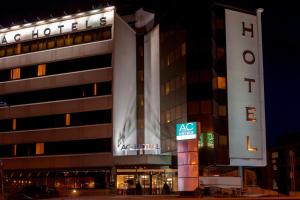 a building with a sign in front of it at AC Hotel Genova by Marriott in Genoa
