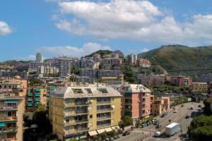 a city with tall buildings and a mountain at AC Hotel Genova by Marriott in Genoa