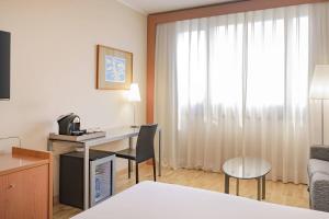 a room with a desk in a hotel room at AC Hotel Genova by Marriott in Genoa
