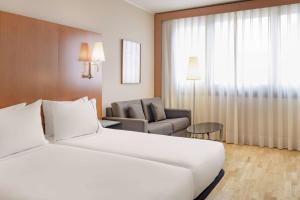 a hotel room with a bed and a chair at AC Hotel Genova by Marriott in Genoa