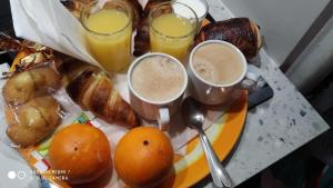 a tray of breakfast foods with two cups of coffee at CHAMBRES tout Confort,GARE TGV ,WIFI,Climatisation, parking,pt dejeuner inclus in Perpignan