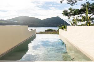 a swimming pool with a view of a body of water at Silveira Bay Lounge Retreat in Angra do Heroísmo