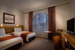 BEST WESTERN PLUS Travel Inn tesisinde bir odada yatak veya yataklar