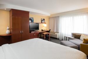 a hotel room with a bed and a couch at Courtyard Des Moines West-Jordan Creek in West Des Moines +17 photos