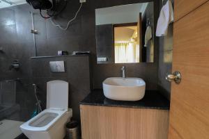 a bathroom with a sink and a toilet at Hotel Colonels Paradise in Rānīkhet +37 photos