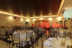 a banquet hall with tables and chairs with white table cloth at Fair crown Suites in Davao City