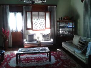 a living room with a couch and a coffee table at Casa Suiza in Luis Guillón