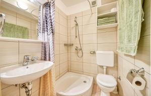 a small bathroom with a sink and a toilet at Apartment Ennio in Povlja