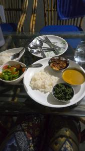a plate of food with rice and vegetables on a table at Prafulla Homestay in Kārwār +3 photos