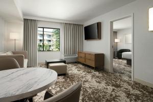 a hotel room with a bed and a table at Courtyard by Marriott Los Angeles Pasadena Old Town in Pasadena