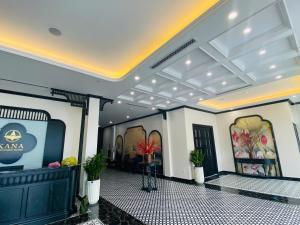 a lobby of a building with a tv and plants at Kana Boutique Hotel Ninh Bình in Ða Gia