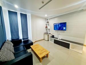 a living room with a couch and a tv at Bualinn Resort in Nong Khai