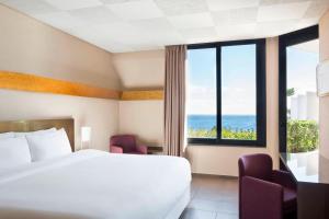 Un ou plusieurs lits dans un hébergement de l'établissement Four Points by Sheraton Catania Hotel