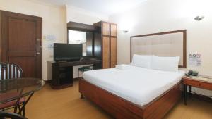 Postel nebo postele na pokoji v ubytování Bliss Hotel Dau