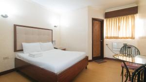 Postel nebo postele na pokoji v ubytování Bliss Hotel Dau