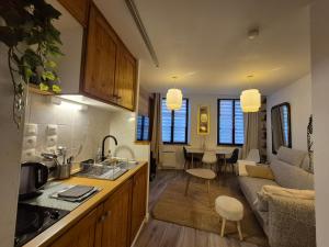 a kitchen and living room with a couch and a table at Cosy appartement Embrun centre in Embrun