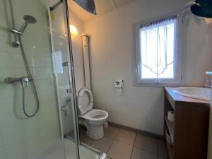 a bathroom with a shower and a toilet and a sink at Maison lumineuse au calme, pres mer in Le Château-dʼOléron +5 photos